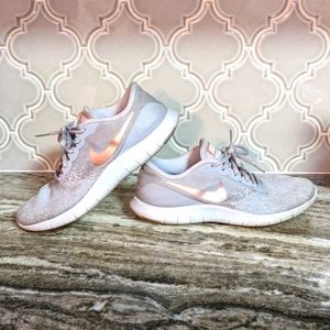 white and rose gold nike shoes